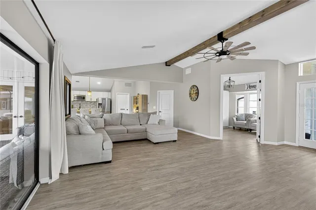 a living room with furniture and a wooden floor