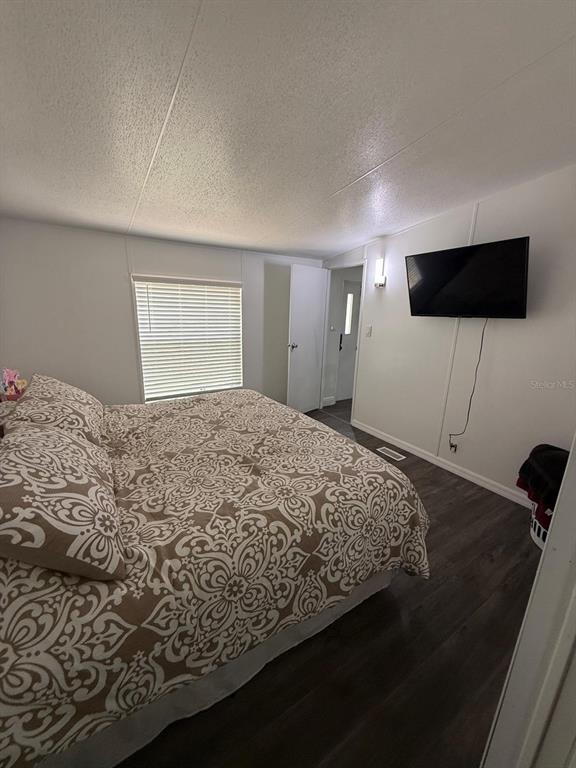 2433 East North Street Inverness, FL 34453 - Photo 8 of 11 a bedroom with a bed and a television
