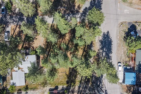 an aerial view of a house with yard and outdoor seating