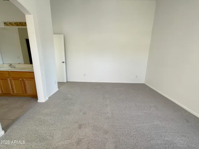 a view of a room with wooden floor and a bathroom