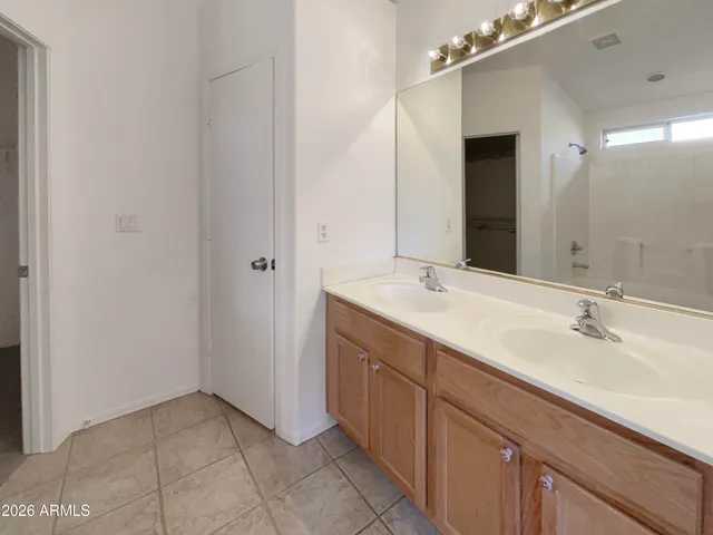 a bathroom with a double vanity sink and a mirror