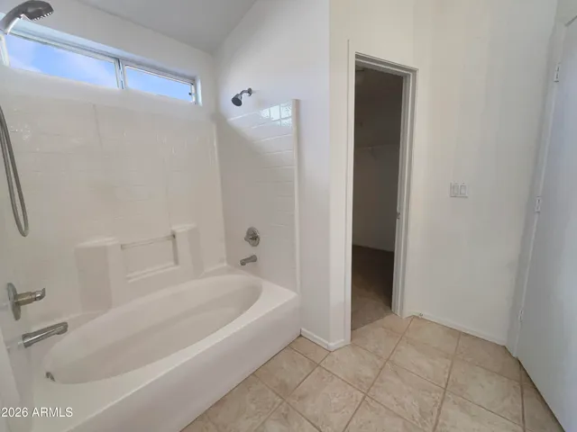 a bathroom with a bathtub and shower