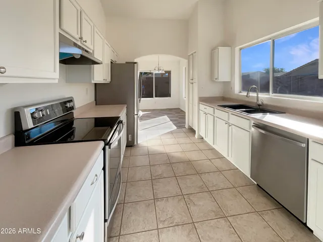 a kitchen with a stove a sink and a refrigerator