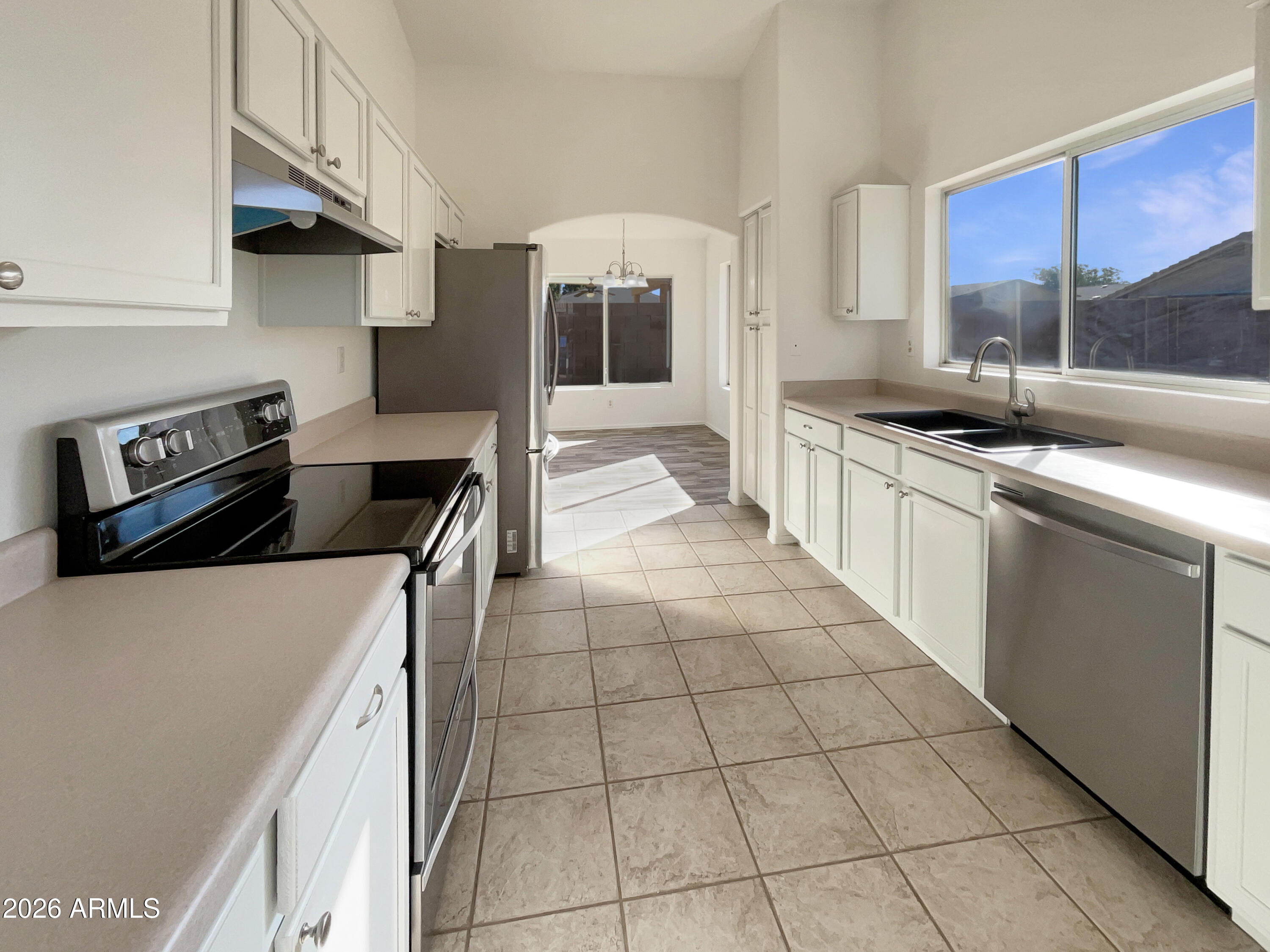 2023 East Wagoner Road Phoenix, AZ 85022 - Photo 20 of 22 a kitchen with a stove a sink and a refrigerator