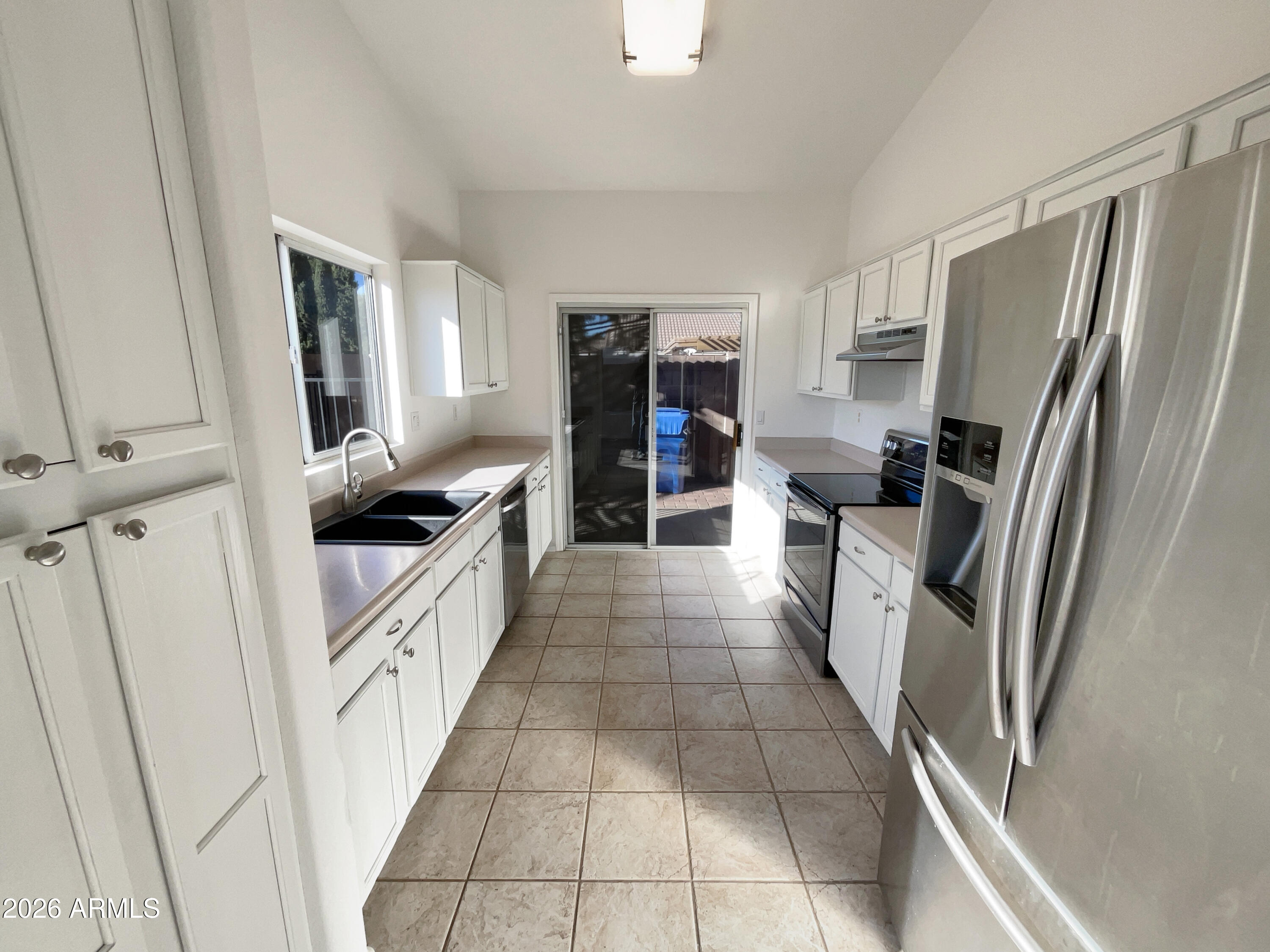 2023 East Wagoner Road Phoenix, AZ 85022 - Photo 2 of 22 a kitchen with granite countertop a refrigerator and a sink