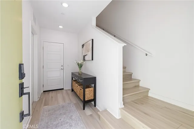 a view of entryway and hall with wooden floor