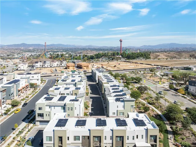 a view of a yard with plants and a bench