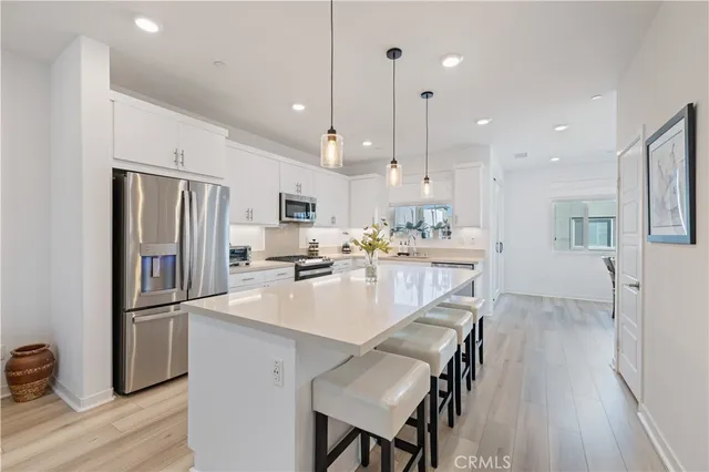a kitchen with white cabinets sink and stainless steel appliances