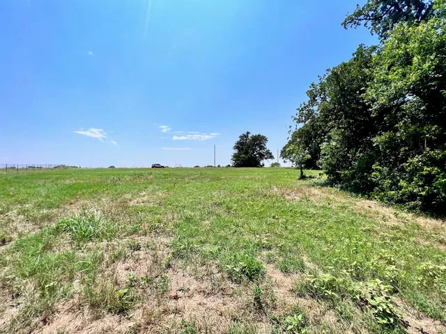 a view of a green field with an outdoor space