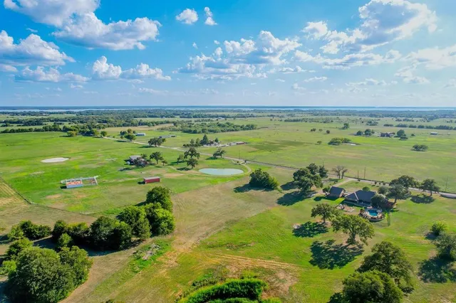 a view of a swimming pool with lawn chairs