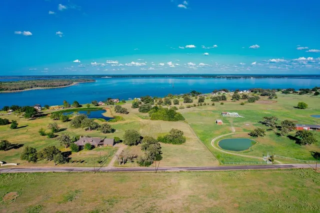 a view of a grassy field with an trees