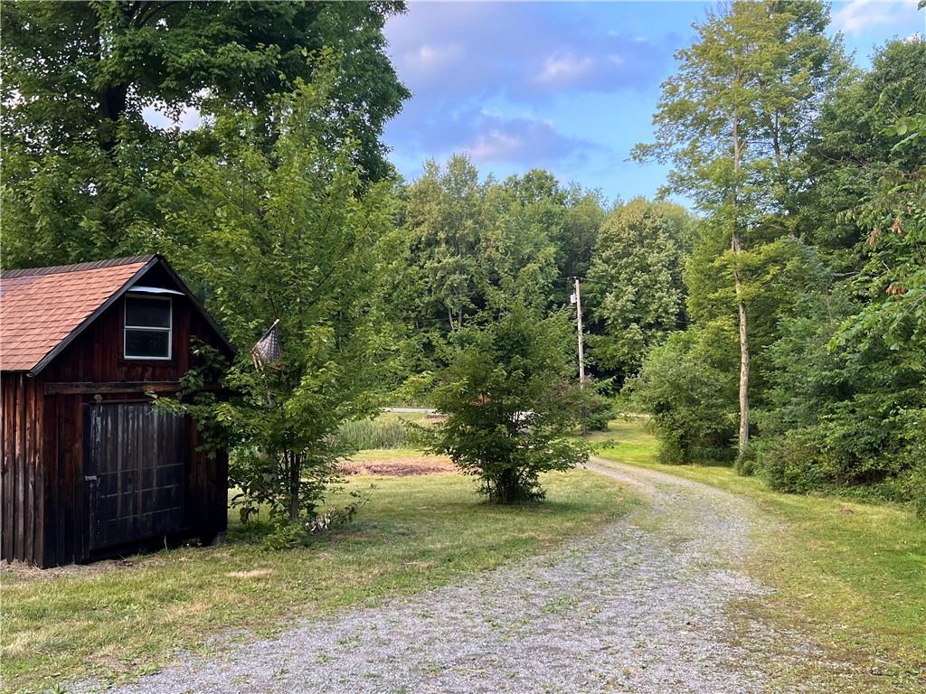 1784 Butler Pike Mercer, PA 16137 - Photo 3 of 25 a view of a yard with wooden fence and a tree