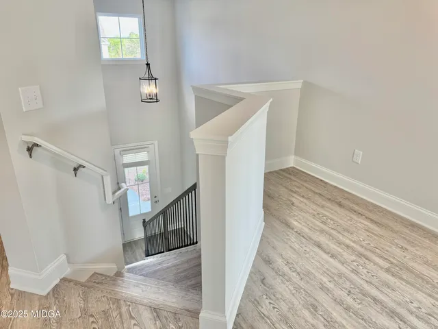 a view of entryway and hall with wooden floor