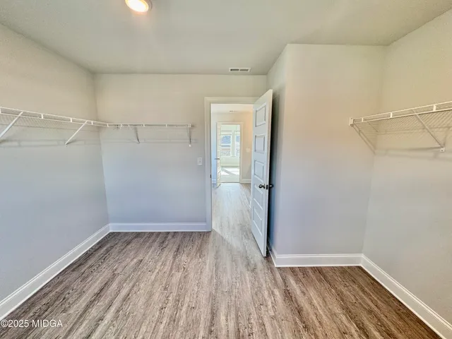 a view of a room with wooden floor and window