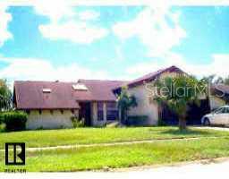 12554 Shadow Ridge Boulevard Hudson, FL 34669 - Photo 1 of 1 a front view of a house with a yard and potted plants