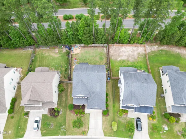 an aerial view of a house with a garden and lake view