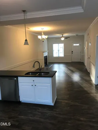 a view of a kitchen with a sink wooden floor and a window