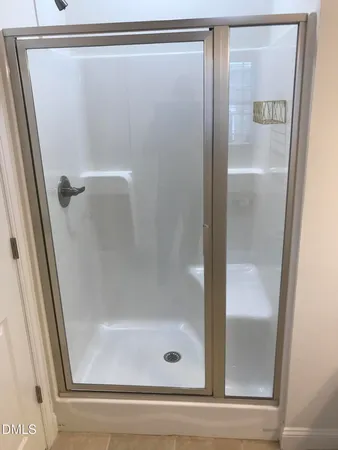 a bathroom with a glass shower door