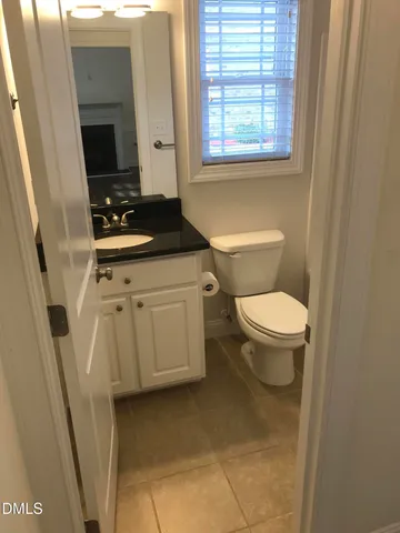 a bathroom with a toilet a sink and a window