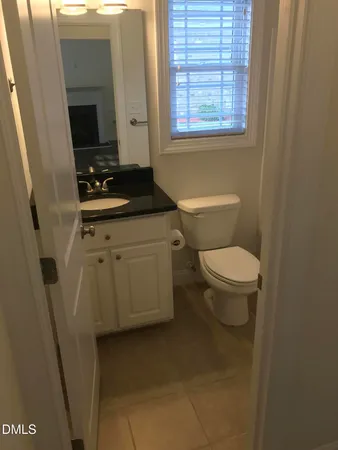 a bathroom with a toilet sink and window