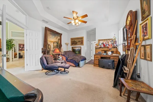 a living room with furniture fireplace and a large window