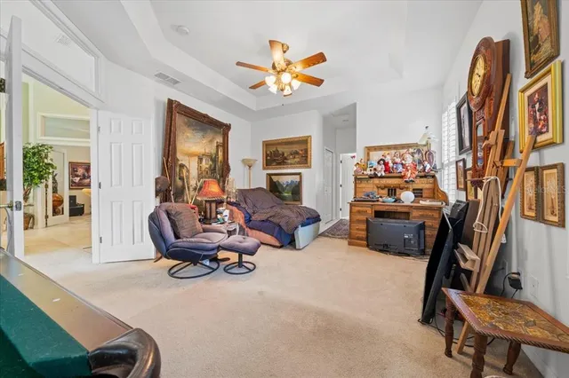 a living room with furniture fireplace and a large window