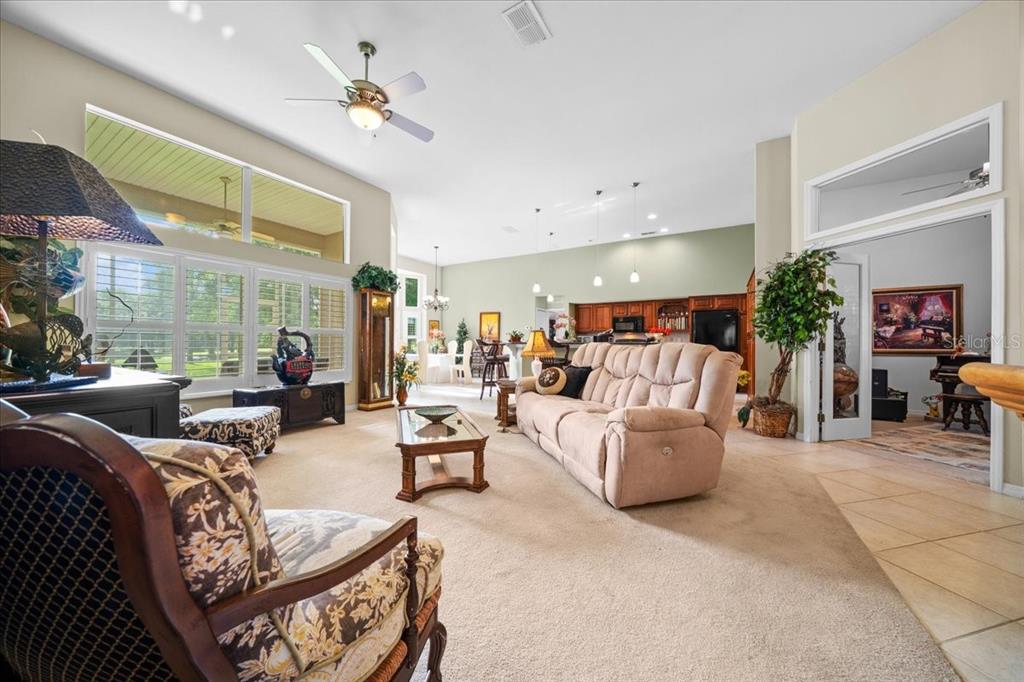 10614 Southwest 71st Terrace Road Ocala, FL 34476 - Photo 9 of 21 a living room with furniture and a large window