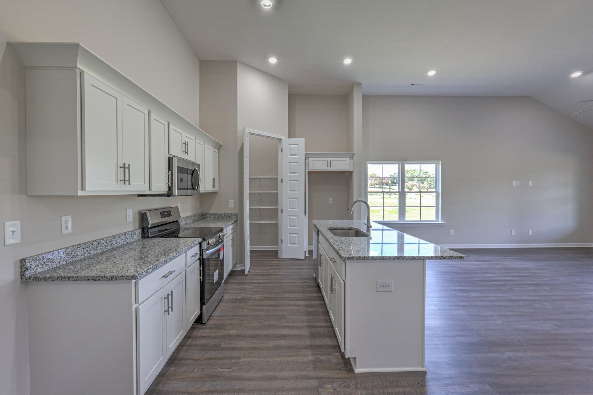 41 Bartow Street Decherd, TN 37324 - Photo 11 of 37 a kitchen with stainless steel appliances granite countertop a stove a sink and a refrigerator