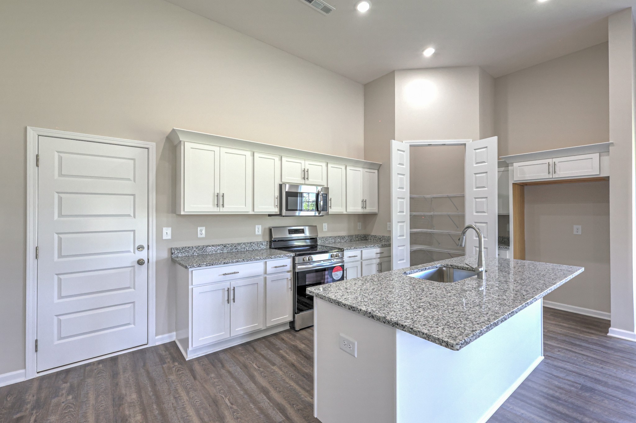 41 Bartow Street Decherd, TN 37324 - Photo 13 of 37 a kitchen with stainless steel appliances granite countertop a sink stove and refrigerator