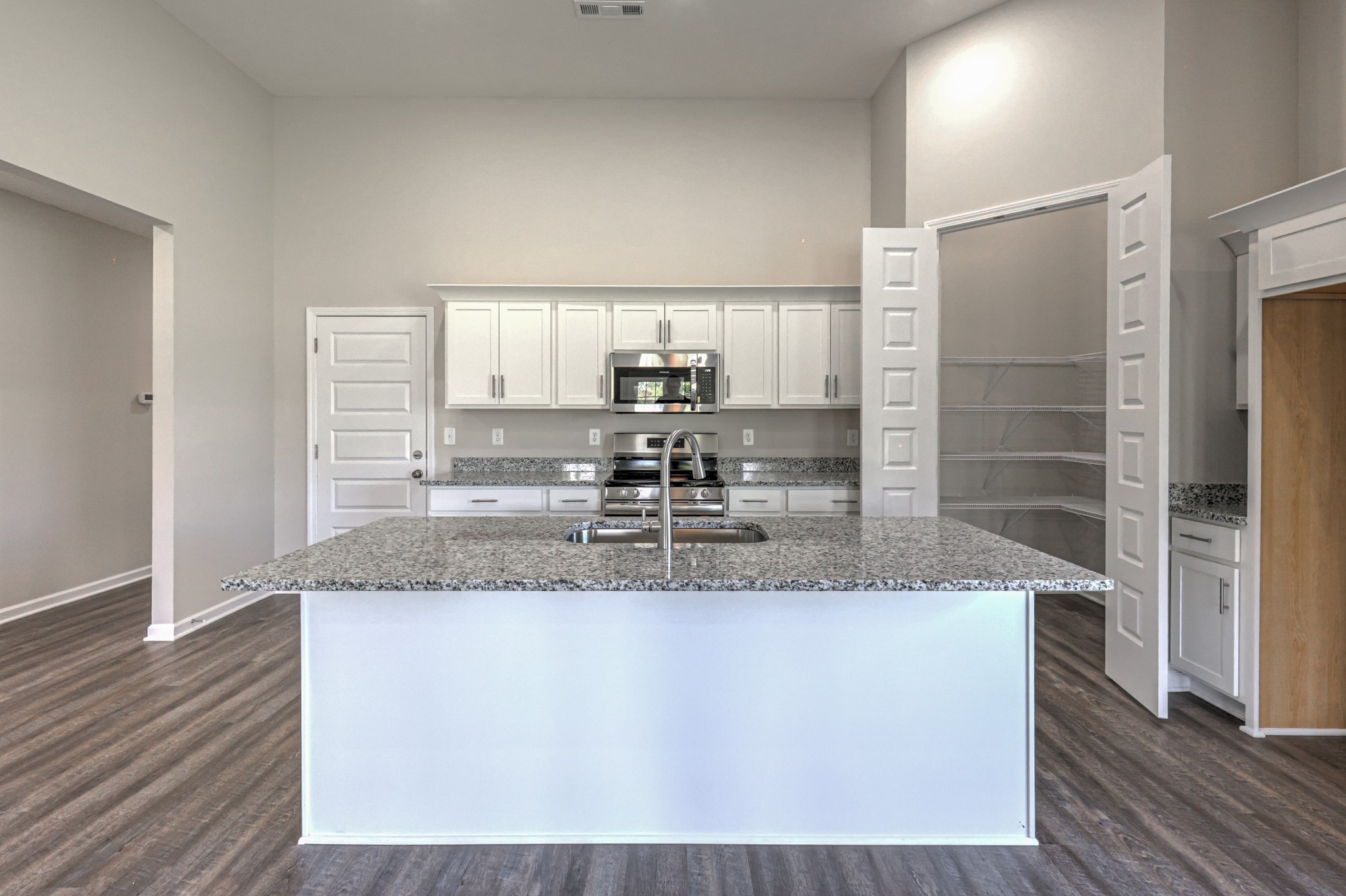 41 Bartow Street Decherd, TN 37324 - Photo 14 of 37 a large kitchen with granite countertop a sink and a refrigerator