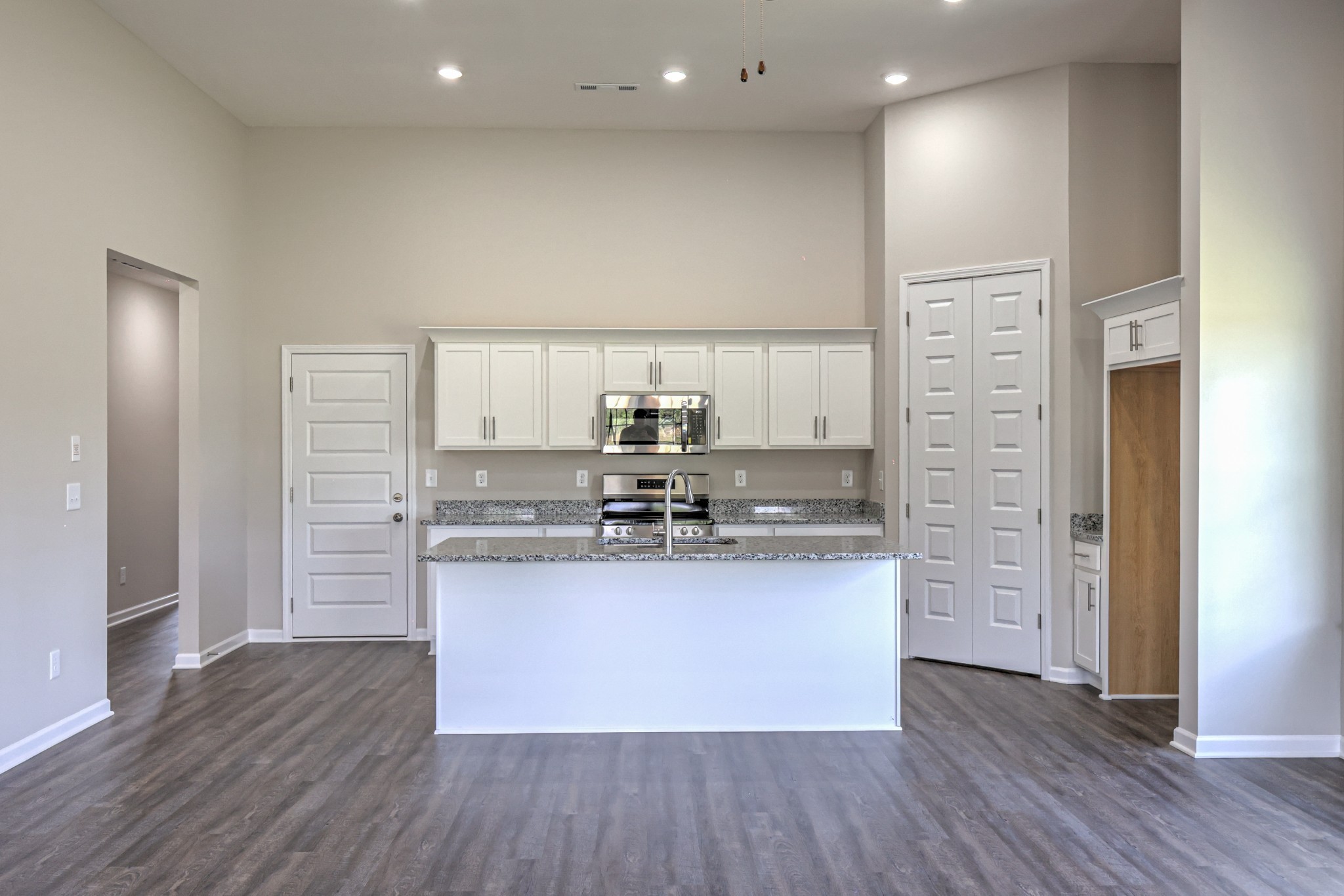 41 Bartow Street Decherd, TN 37324 - Photo 21 of 37 a kitchen with stainless steel appliances granite countertop a sink and a refrigerator