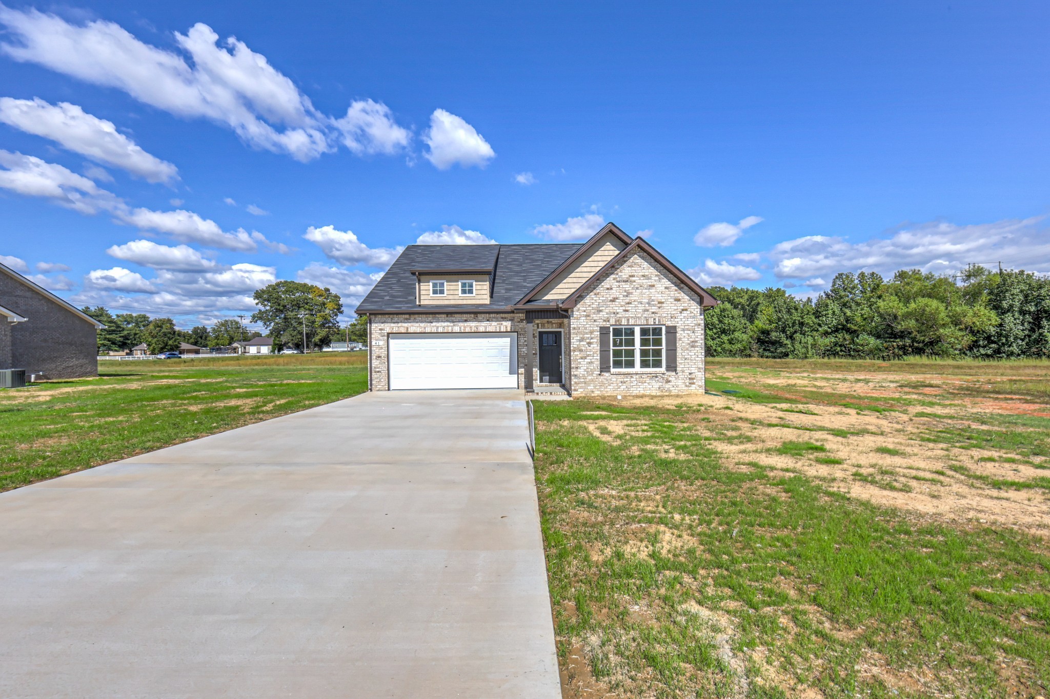 41 Bartow Street Decherd, TN 37324 - Photo 3 of 37 a front view of a house with a yard and garage