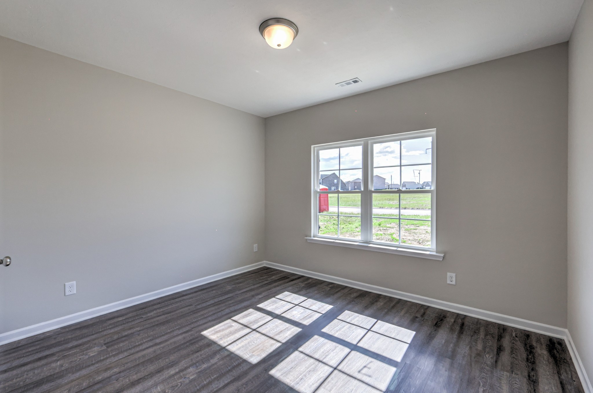 41 Bartow Street Decherd, TN 37324 - Photo 6 of 37 an empty room with wooden floor and windows