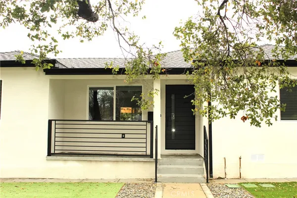 a view of a house with a large tree