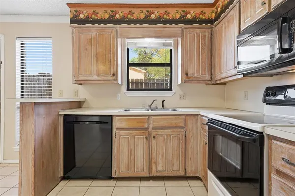 a kitchen with stainless steel appliances granite countertop a sink stove and microwave