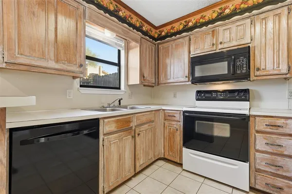 a kitchen with granite countertop a refrigerator and a sink