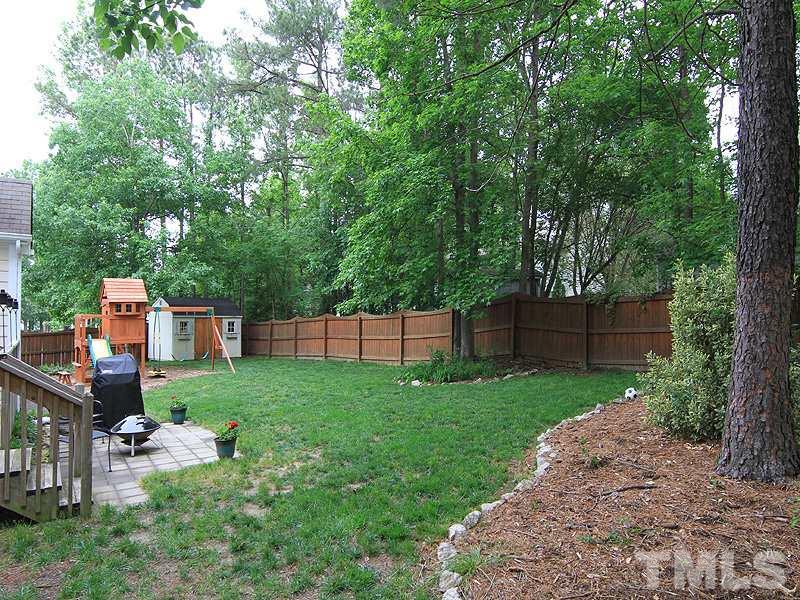 3601 Hopper Street Raleigh, NC 27616 - Photo 12 of 13 a view of a backyard with potted plants and large tree