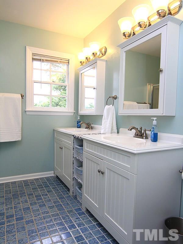 3601 Hopper Street Raleigh, NC 27616 - Photo 8 of 13 a bathroom with a sink vanity and mirror