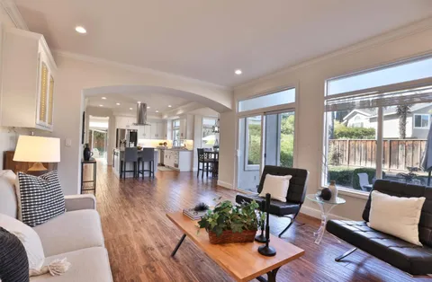 a living room with furniture and floor to ceiling windows