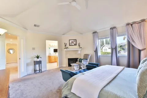 a bedroom with a bed and a large window