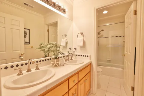 a bathroom with a double vanity sink and a mirror