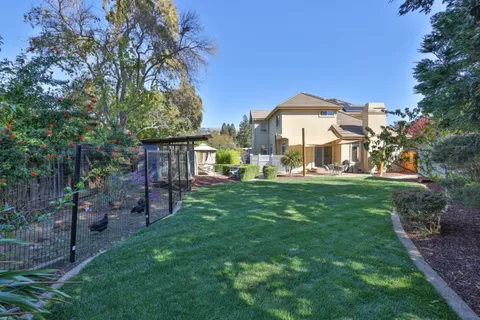 a view of a house with a backyard