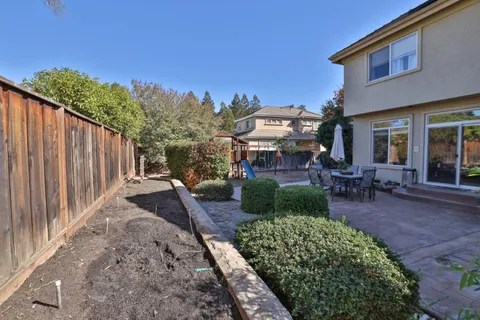 a view of a backyard with sitting area