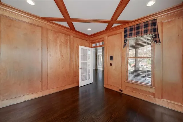 an empty room with a ceiling fan and window