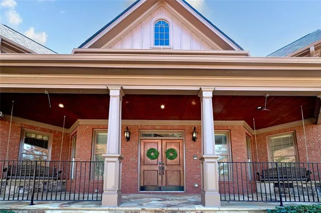 a view of staircase with lots of frames on wall and wooden floor