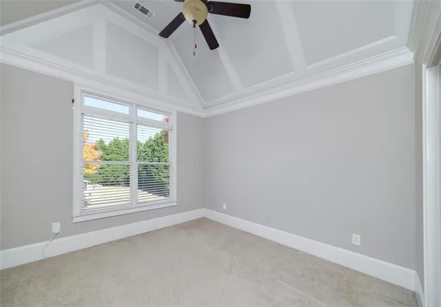 a living room with furniture a fireplace and a floor to ceiling window