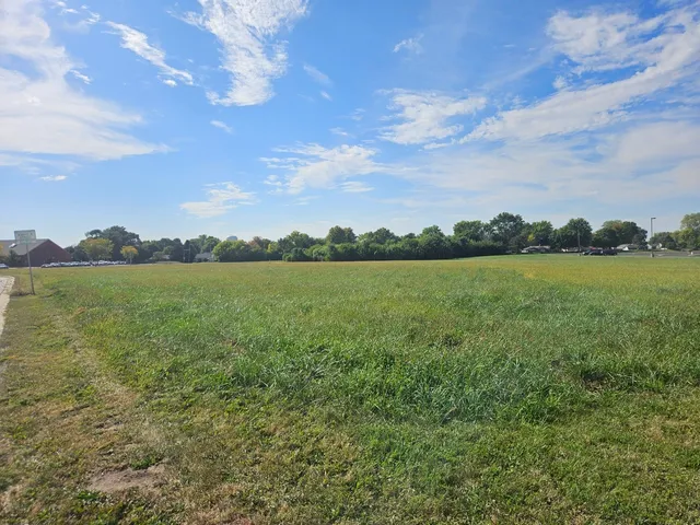 a view of a lake with houses in the back