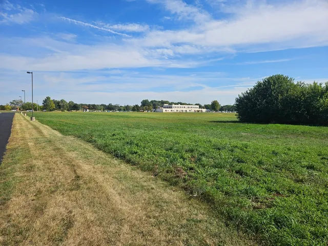 a view of a field with an ocean