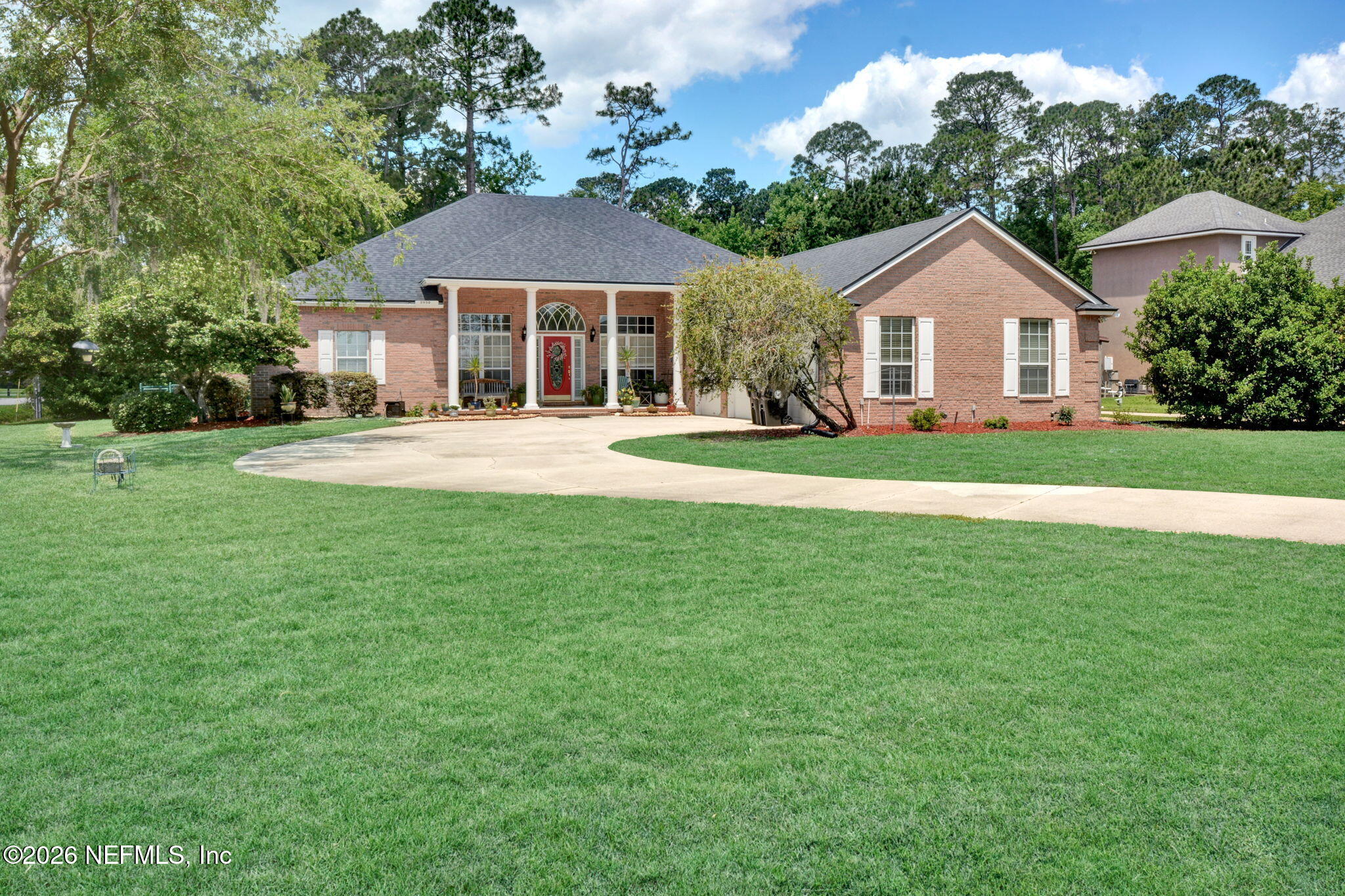 5950 West Shores Road Orange Park, FL 32003 - Photo 1 of 42 a front view of a house with a yard and trees