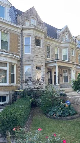a front view of a house with a yard and trees